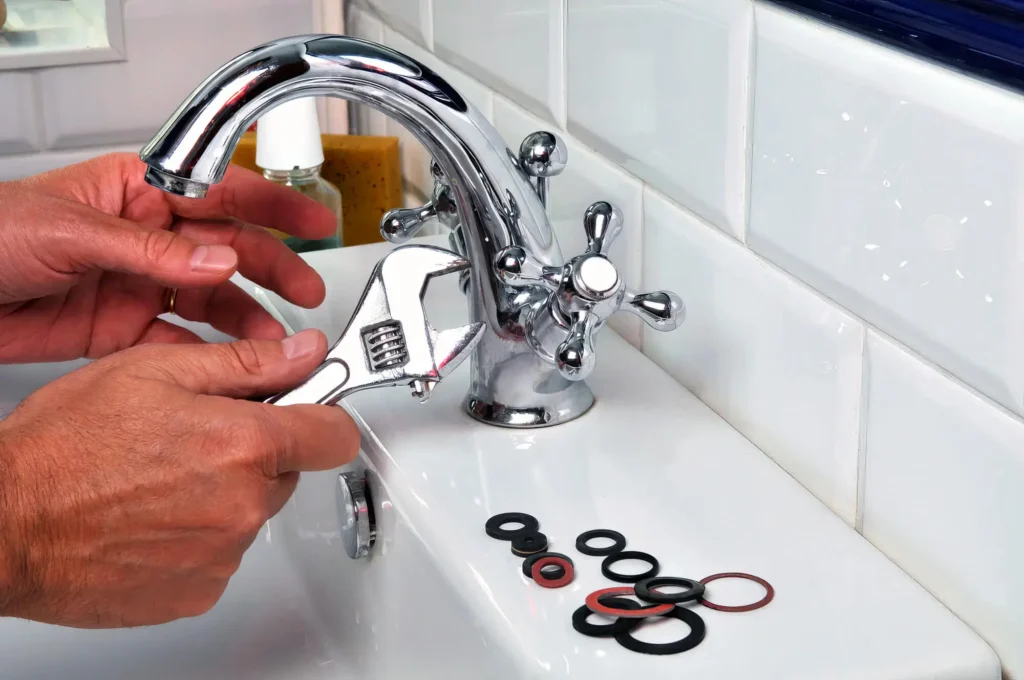 Plumber performing maintenance on a bathroom faucet in Wesley Chapel