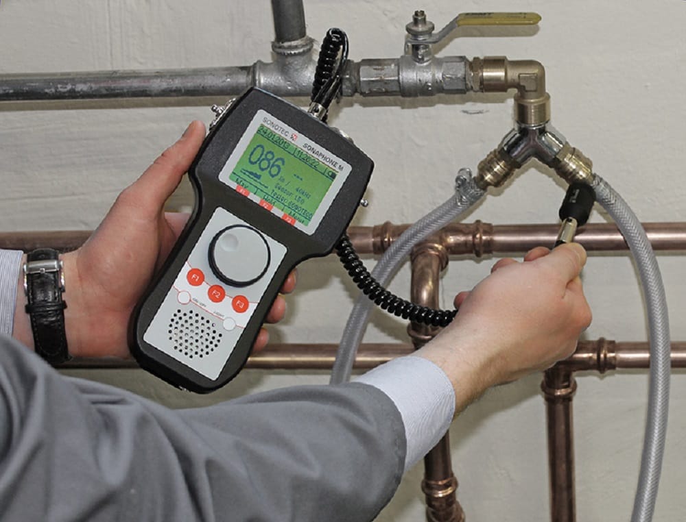 Plumber testing pipes with electronic leak detection equipment in Wesley Chapel