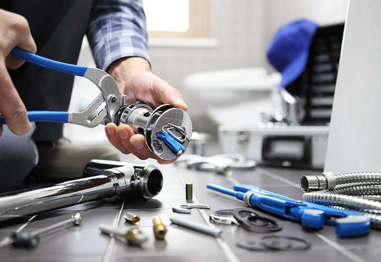 Technician repairing a plumbing fixture with professional tools in Wesley Chapel