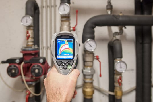 Plumber using a thermal imaging camera to inspect pipes in Wesley Chapel