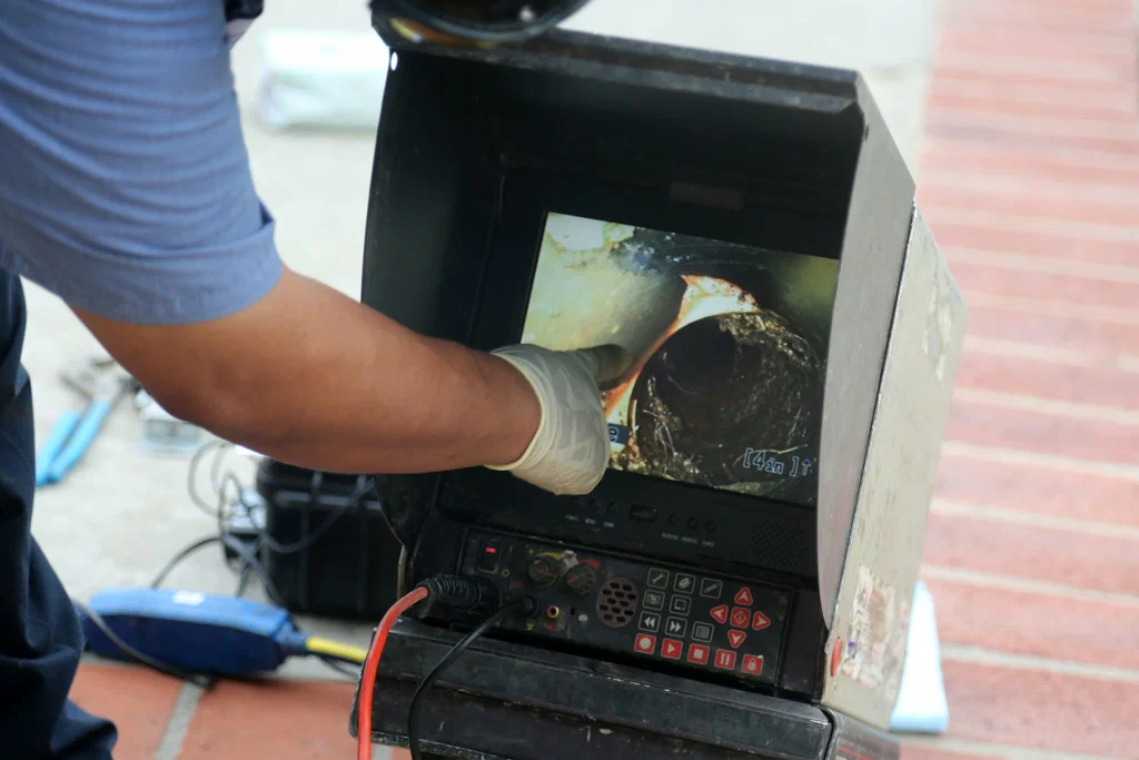 Technician viewing a drain inspection camera in Wesley Chapel
