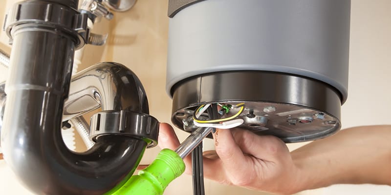 Technician repairing the heating element of a water heater in Wesley Chapel