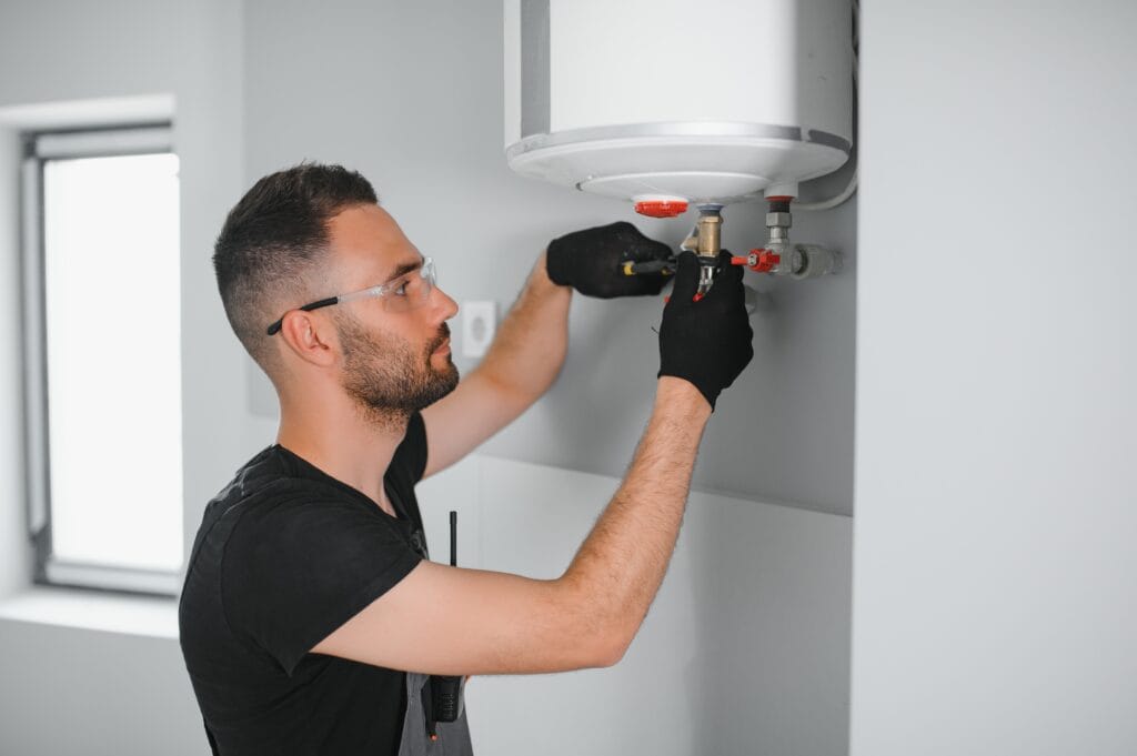 Technician performing water heater maintenance in Wesley Chapel