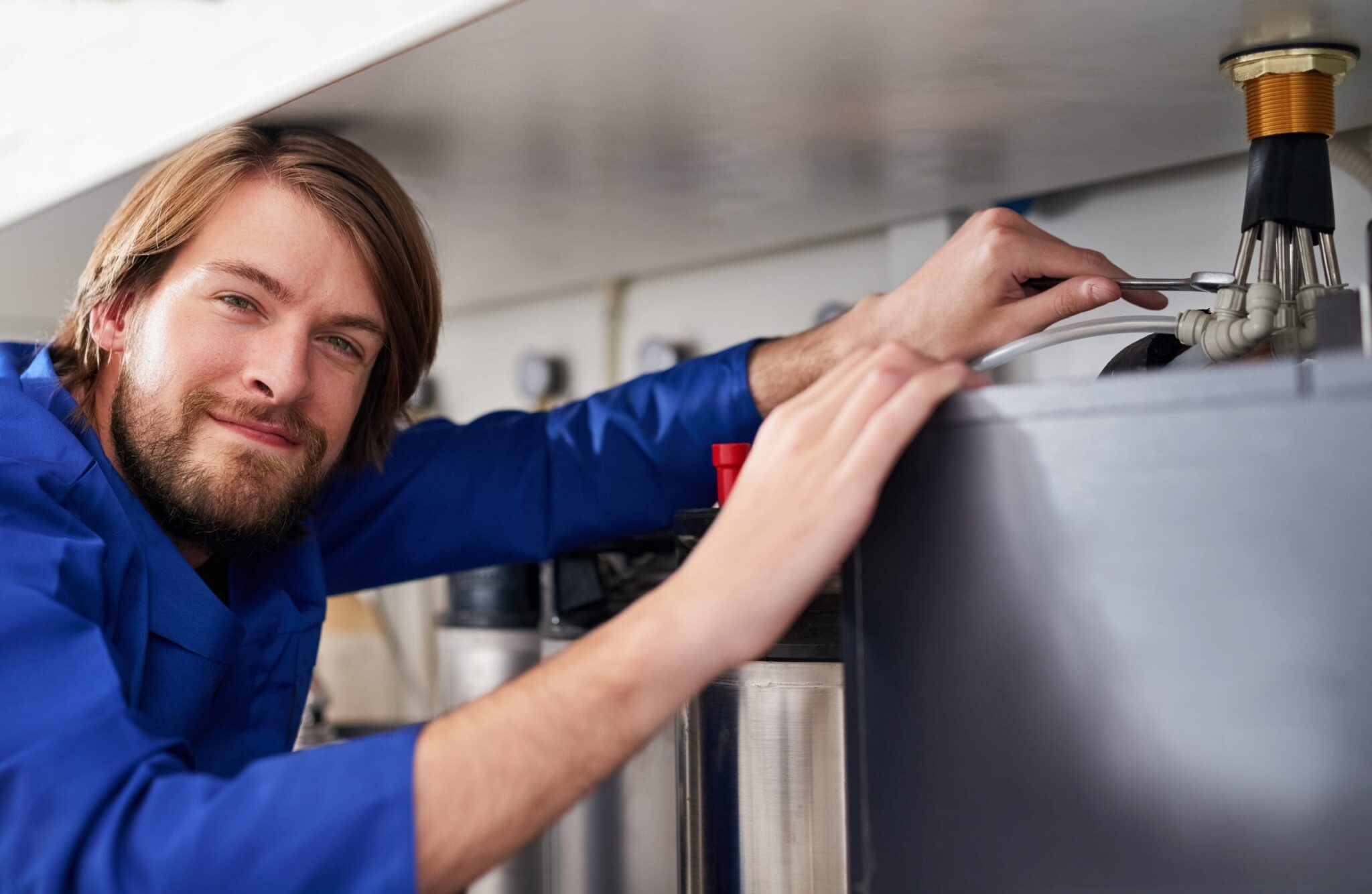 Technician servicing a residential water heater tank in Wesley Chapel