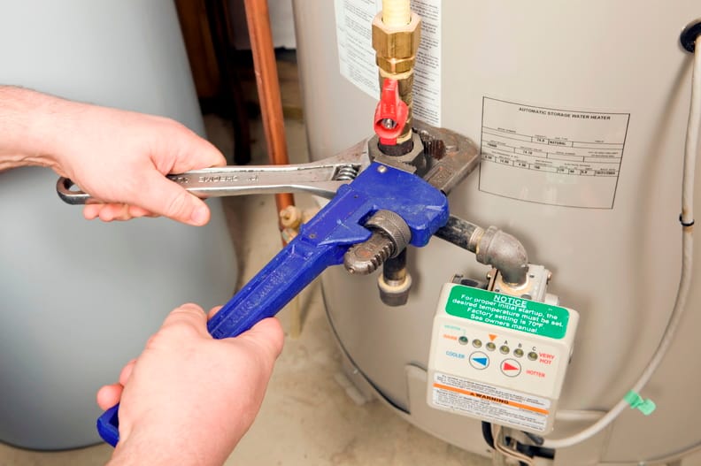 Plumber repairing a water heater valve in Wesley Chapel